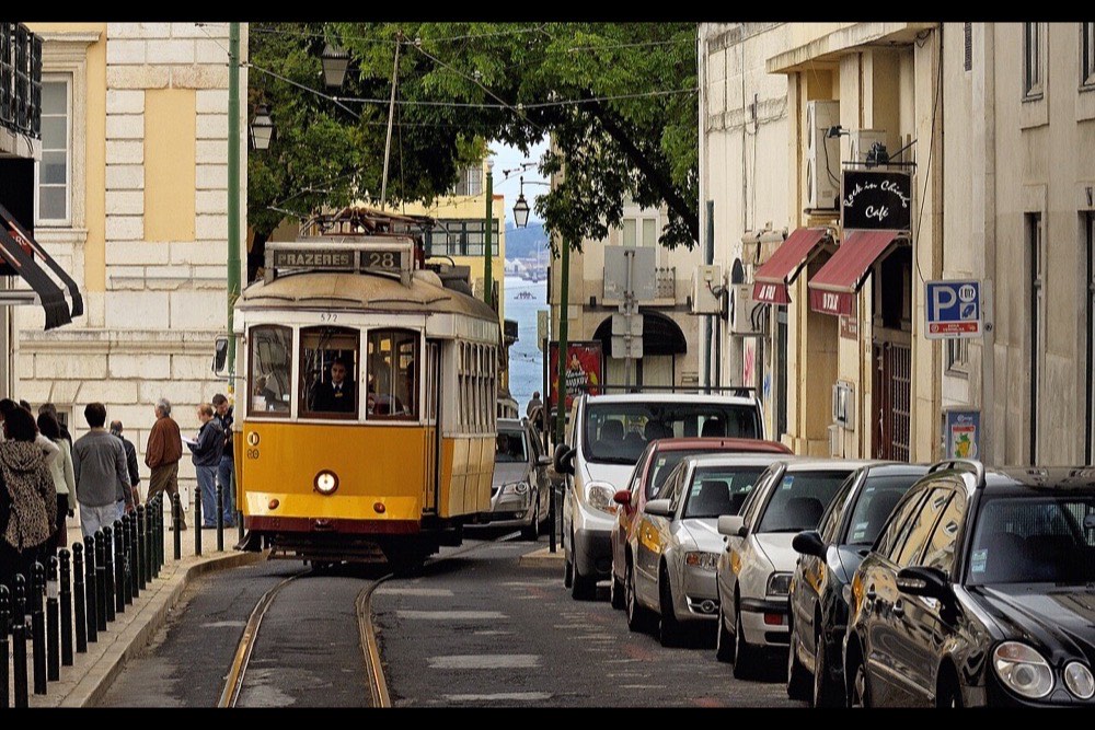 Tram 28 climbing a street in Lisbon